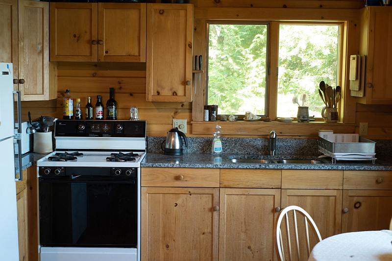 Kitchen showing sink, stove, and granite countertop